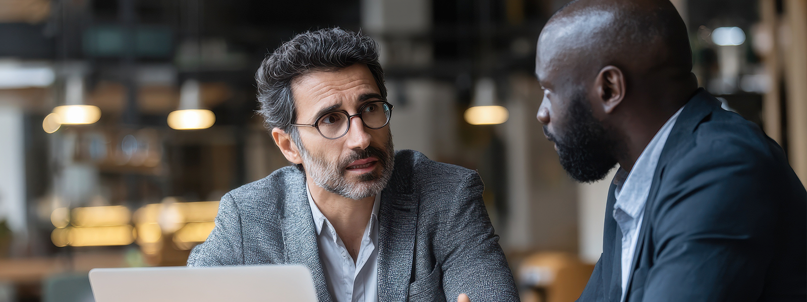 Two older gentlemen talking about a concerning topic