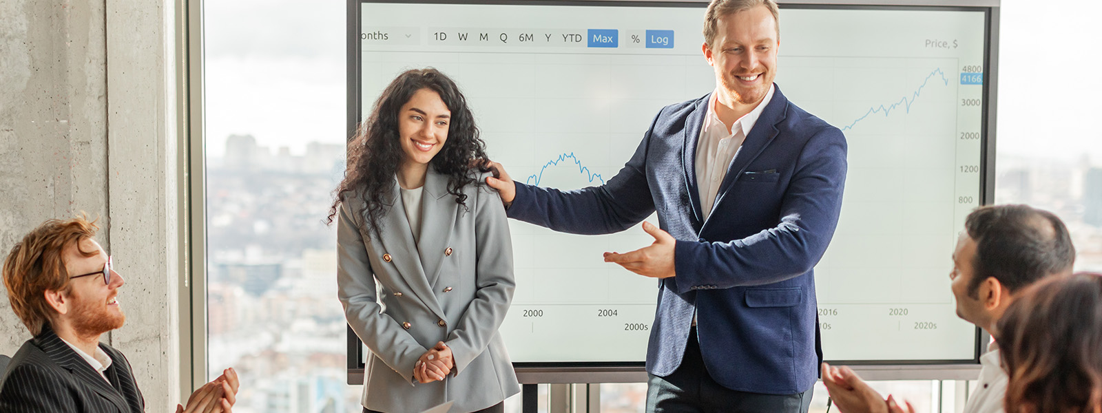 A manager recognizing a team member during a meeting.