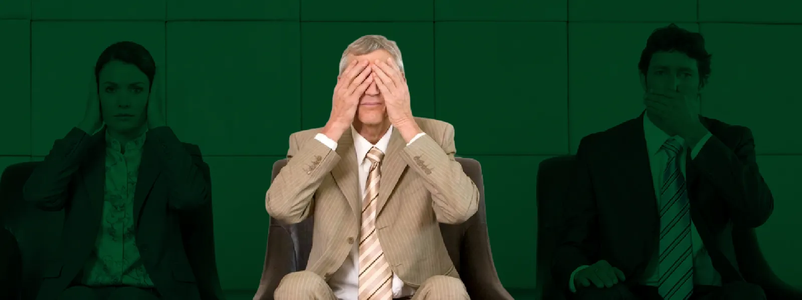 a businessman covering his eyes
