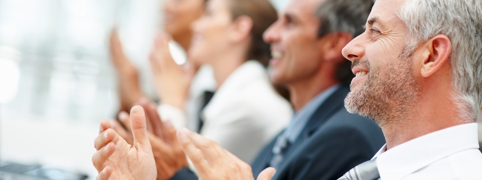 Executives clap at a presentation