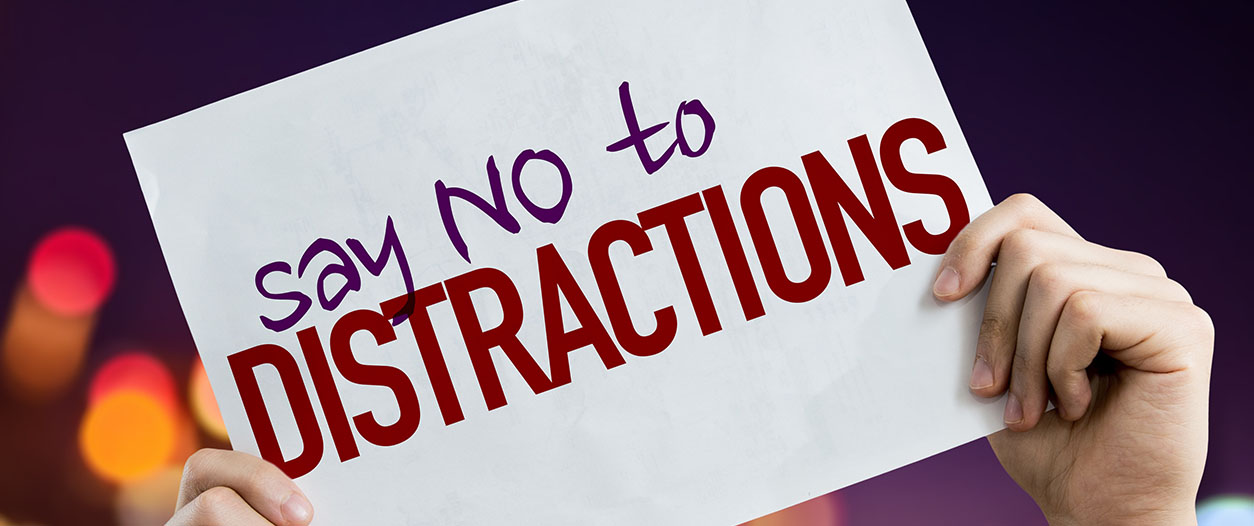 In this image, a person is encouraging others to focus and avoid distractions. Full Text: say NO to DISTRACTIONS