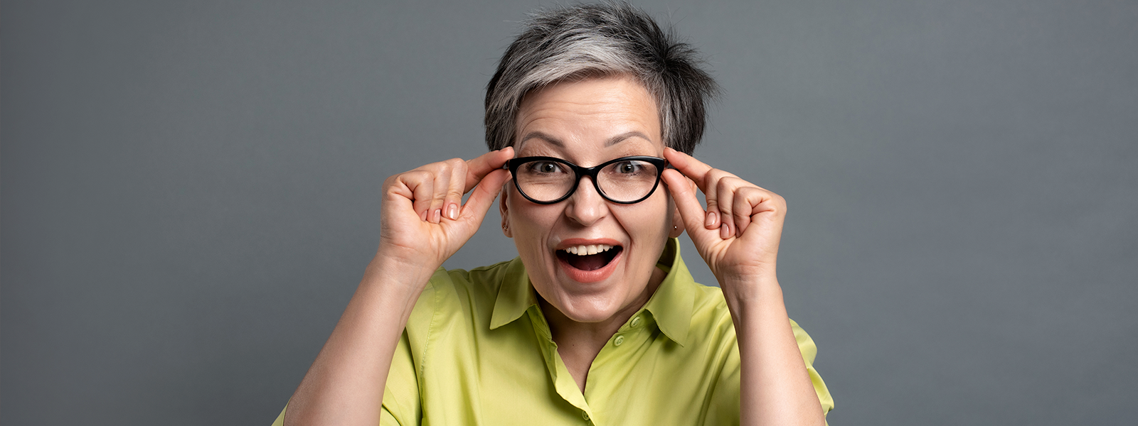 A GenX woman wearing glasses, looking directly at the camera.