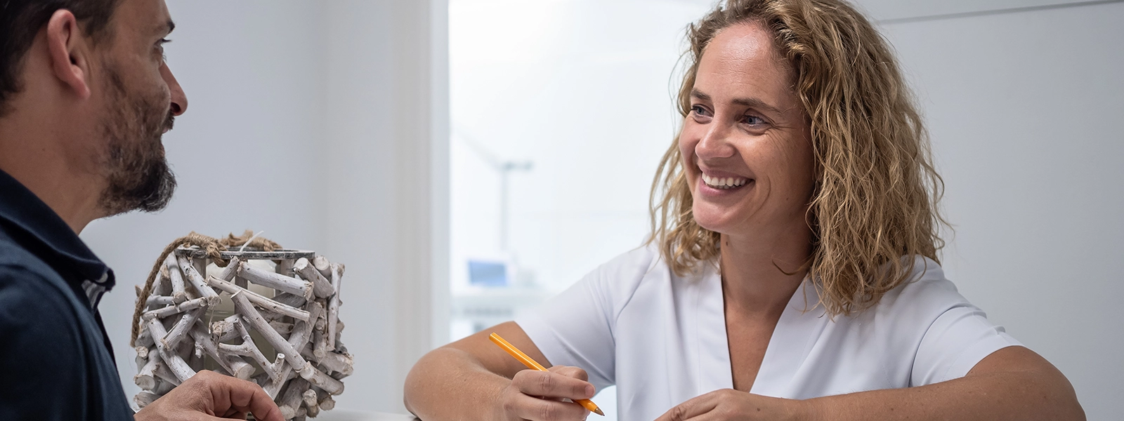a photo of a happy receptionist helping a customer