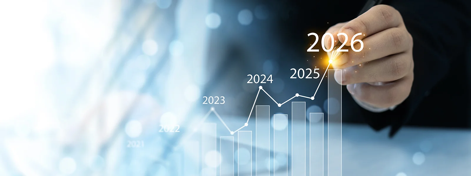A photo illustration of a finger following a line graph rising into 2026