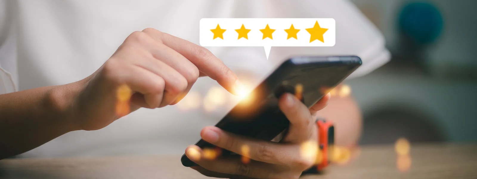 A photo illustration of a person giving a 5 star rating on their phone